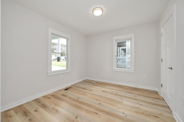 unfurnished room with light wood-type flooring