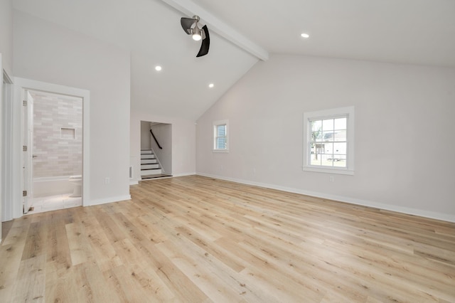 unfurnished living room with lofted ceiling with beams and light hardwood / wood-style flooring