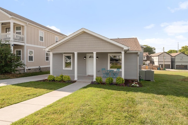 view of front facade with a porch, central AC unit, and a front lawn