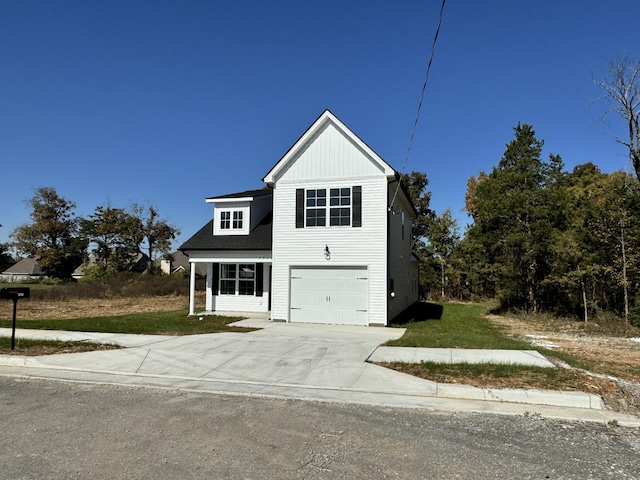 front of property featuring a front yard and a garage