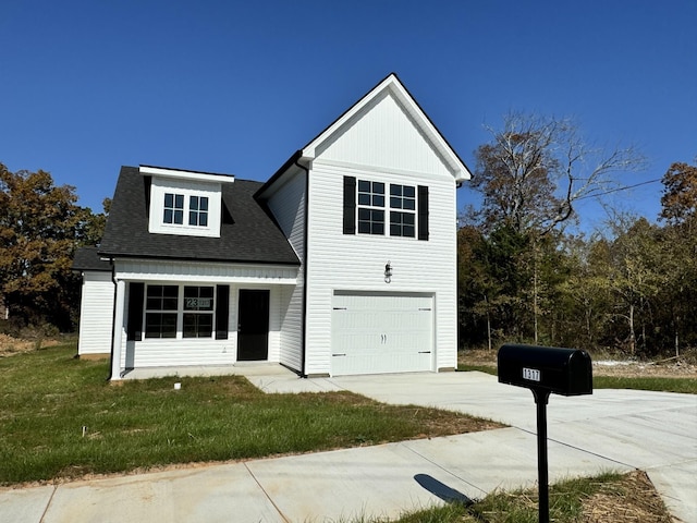 front facade with a front yard and a garage