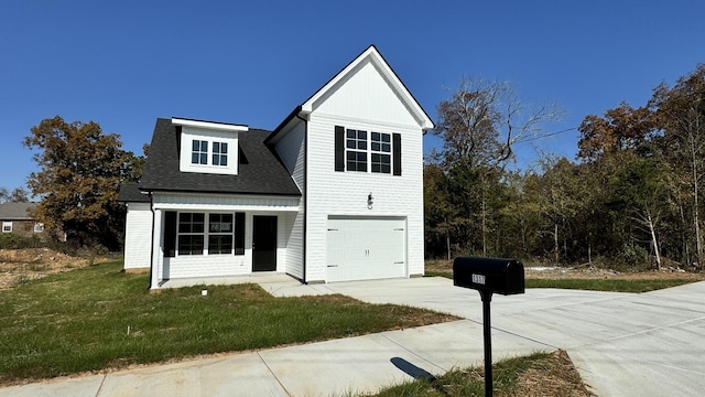 view of front of house with a front lawn and a garage