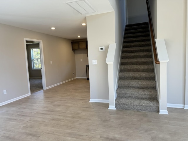 stairway with hardwood / wood-style flooring