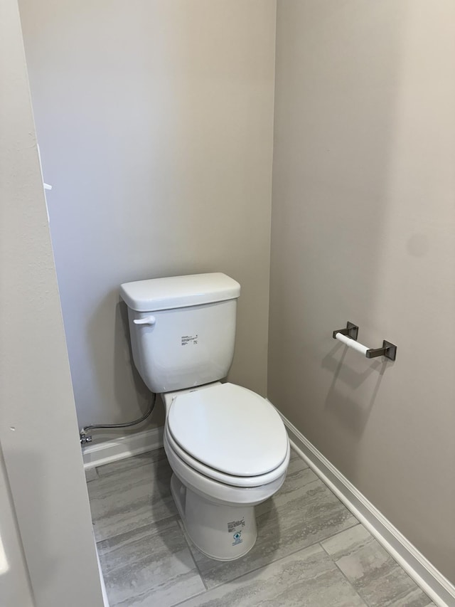 bathroom featuring hardwood / wood-style flooring and toilet