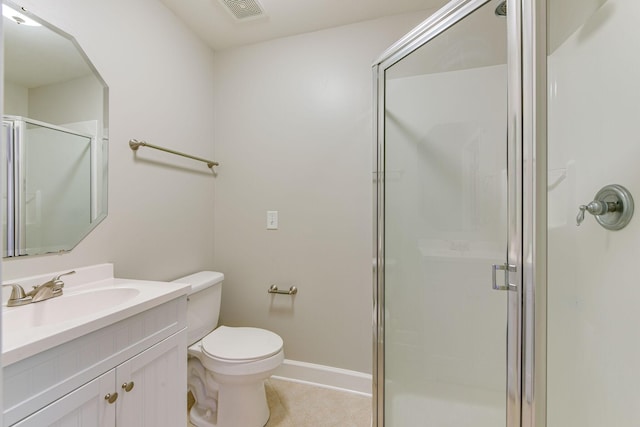 bathroom featuring vanity, toilet, and a shower with shower door