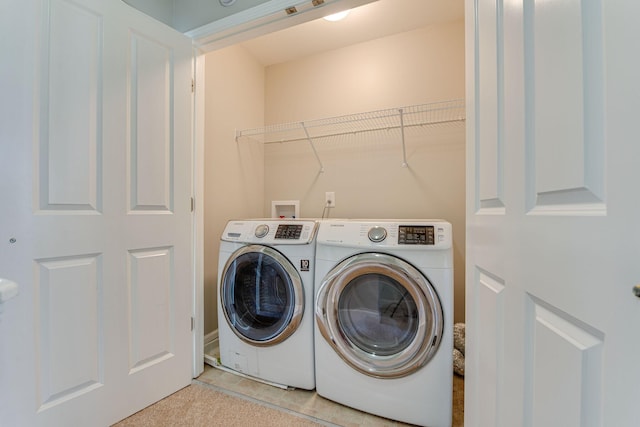 laundry area featuring washing machine and clothes dryer