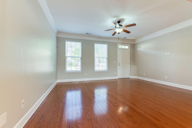 spare room featuring wood-type flooring, ceiling fan, and crown molding