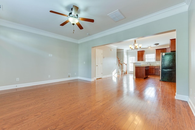 unfurnished living room with sink, light hardwood / wood-style floors, ceiling fan with notable chandelier, and ornamental molding