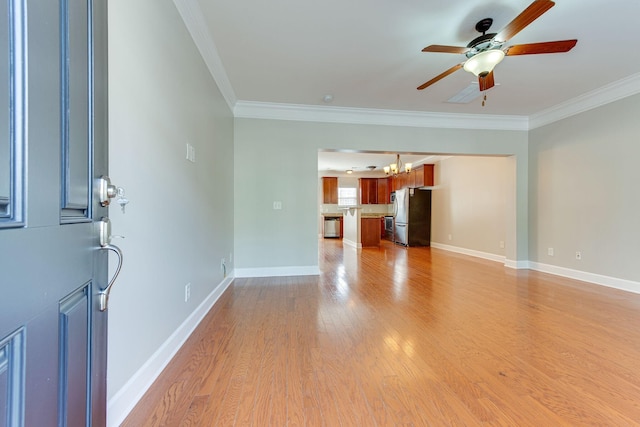 unfurnished living room featuring ceiling fan with notable chandelier, light hardwood / wood-style floors, and crown molding