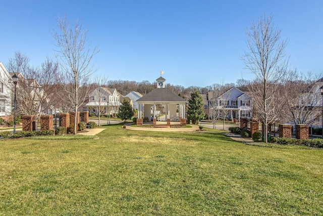 view of front of property featuring a front yard and a gazebo