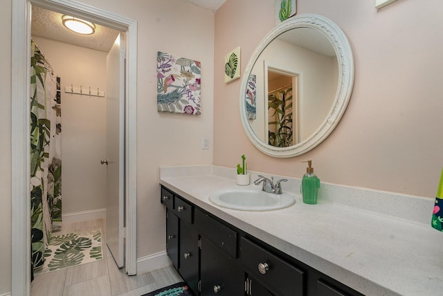 bathroom with vanity and a textured ceiling