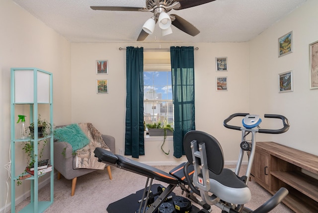 workout room featuring a textured ceiling, carpet floors, and ceiling fan