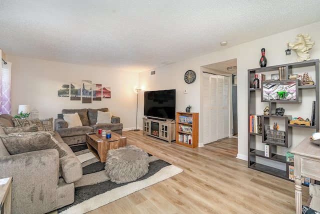 living room featuring hardwood / wood-style floors and a textured ceiling