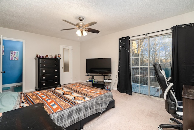 carpeted bedroom featuring ceiling fan, access to exterior, and a textured ceiling