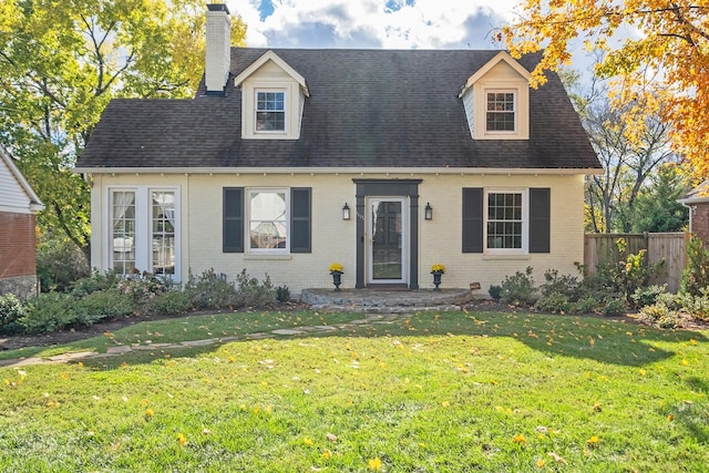 cape cod home featuring a front lawn