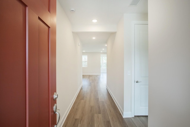 corridor with light hardwood / wood-style floors