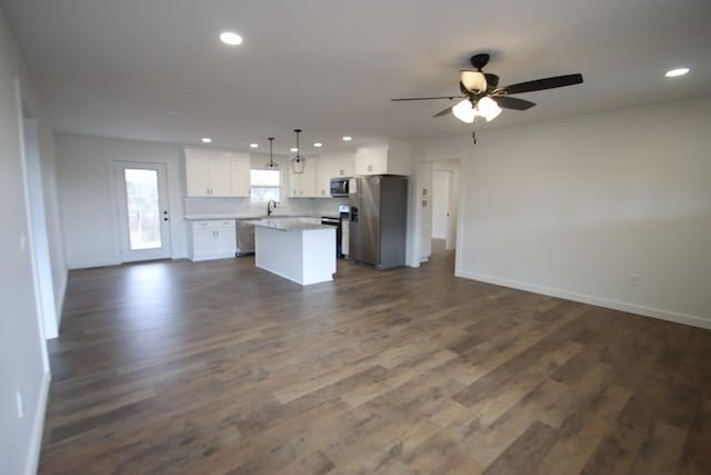 kitchen with pendant lighting, a center island, white cabinets, sink, and stainless steel appliances