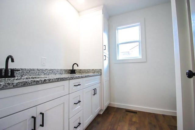 bathroom with hardwood / wood-style flooring and vanity