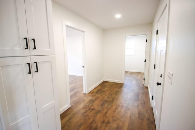 corridor with dark wood-type flooring