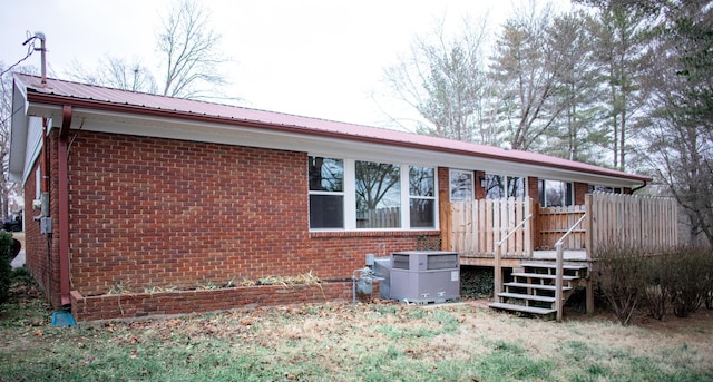 back of property featuring a wooden deck