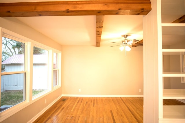 unfurnished room featuring ceiling fan, beam ceiling, and light hardwood / wood-style flooring