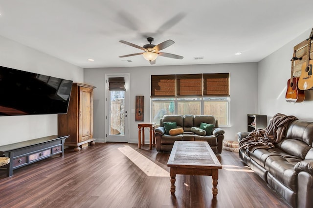 living room featuring dark hardwood / wood-style floors and ceiling fan