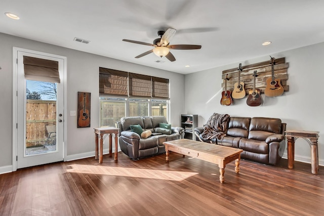 living room featuring ceiling fan and hardwood / wood-style floors