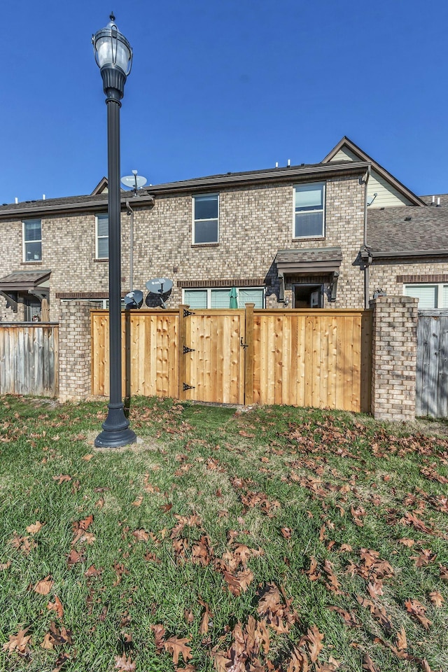 rear view of property featuring a yard