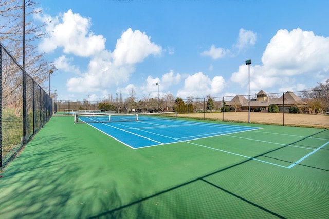 view of tennis court with basketball hoop