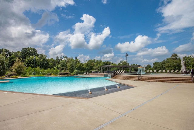 view of swimming pool with a pergola and pool water feature