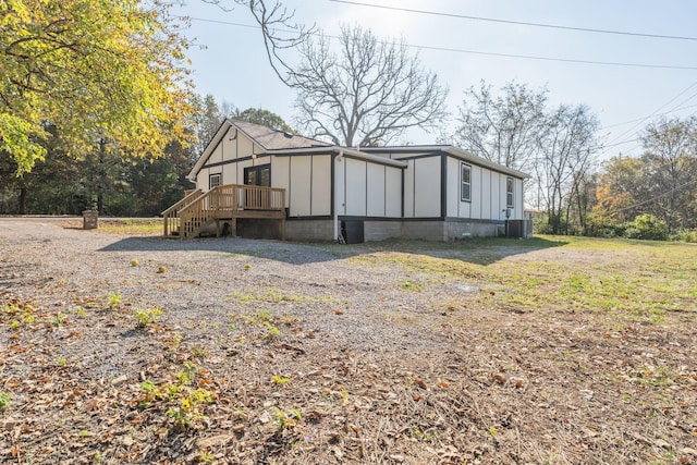 exterior space with a deck and central AC unit