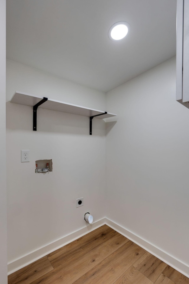 clothes washing area featuring washer hookup, wood-type flooring, and hookup for an electric dryer