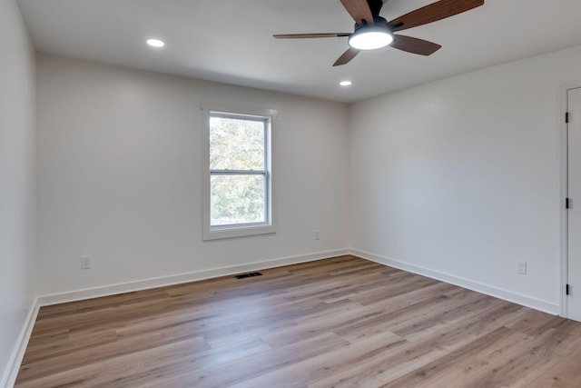 empty room featuring ceiling fan and light hardwood / wood-style floors