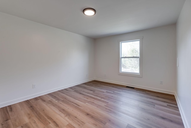 unfurnished room with light hardwood / wood-style flooring