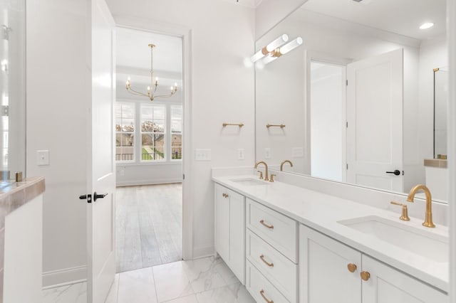 bathroom with vanity and an inviting chandelier