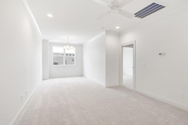 spare room with ceiling fan with notable chandelier, light colored carpet, and ornamental molding