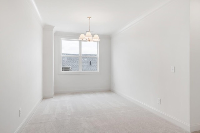 carpeted spare room featuring crown molding and a notable chandelier