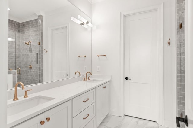 bathroom featuring ornamental molding, vanity, and a shower with shower door