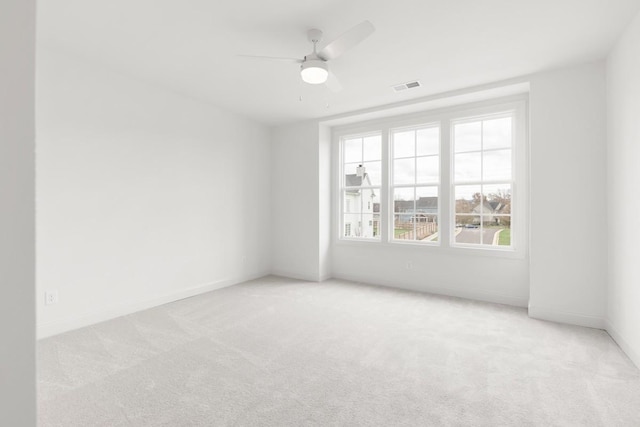 empty room featuring light carpet and ceiling fan