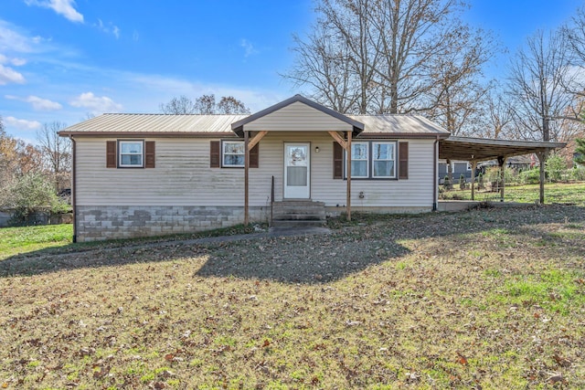 ranch-style house featuring a front yard and a carport