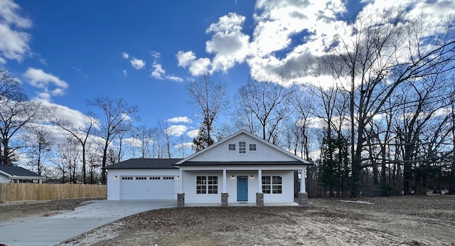 view of front of property with a porch and a garage