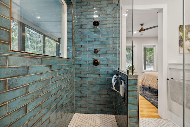 bathroom with tile patterned floors, ceiling fan, and tiled shower