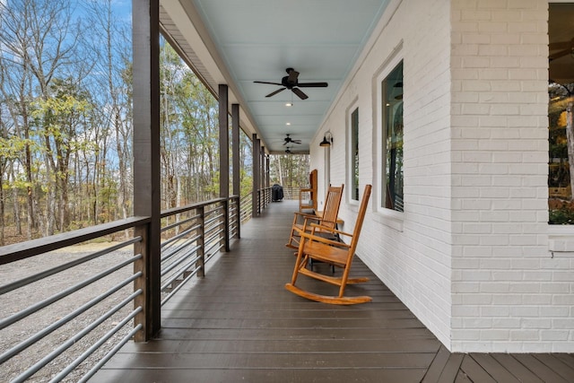 wooden terrace featuring ceiling fan