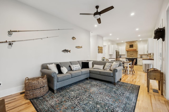 living room featuring ceiling fan and light wood-type flooring