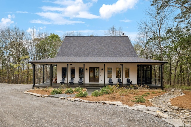 farmhouse featuring ceiling fan and covered porch