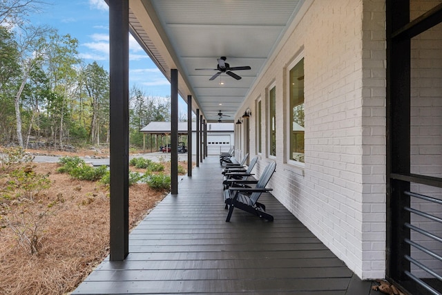 deck with ceiling fan and covered porch