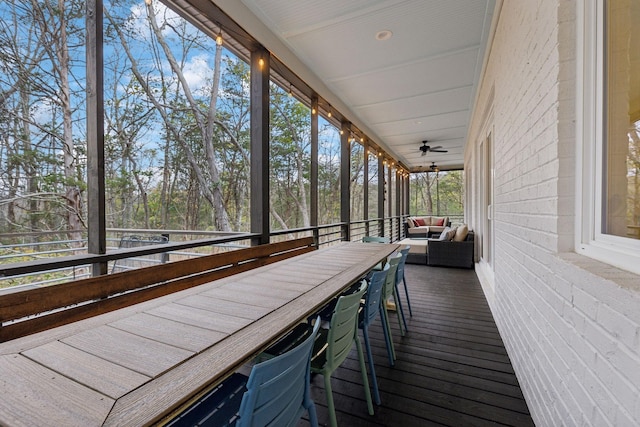 sunroom / solarium featuring ceiling fan