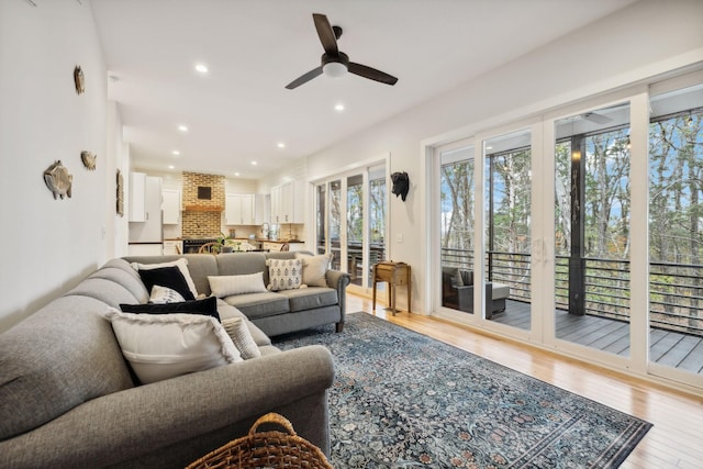 living room featuring light hardwood / wood-style flooring and ceiling fan