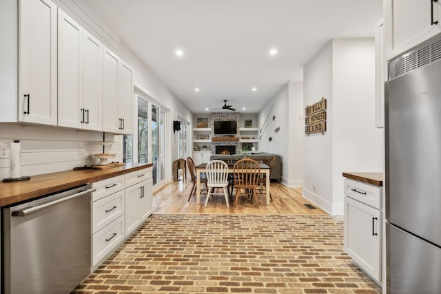 kitchen featuring wood counters, white cabinetry, and appliances with stainless steel finishes