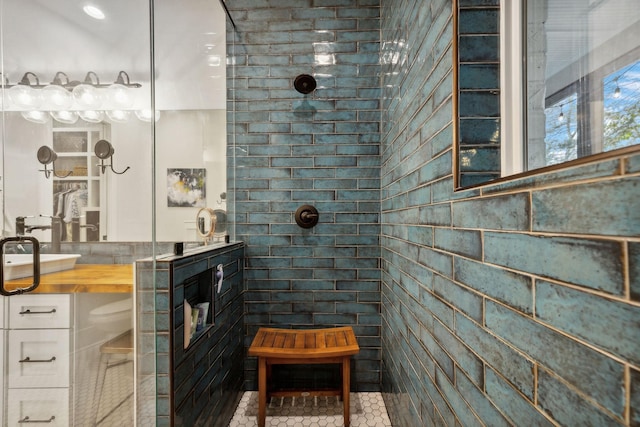 bathroom with tile patterned flooring, a shower, and sink